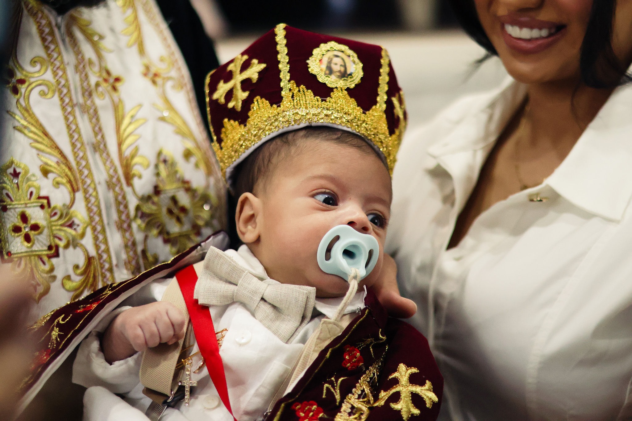 Baby wearing a ceremonial christening crown