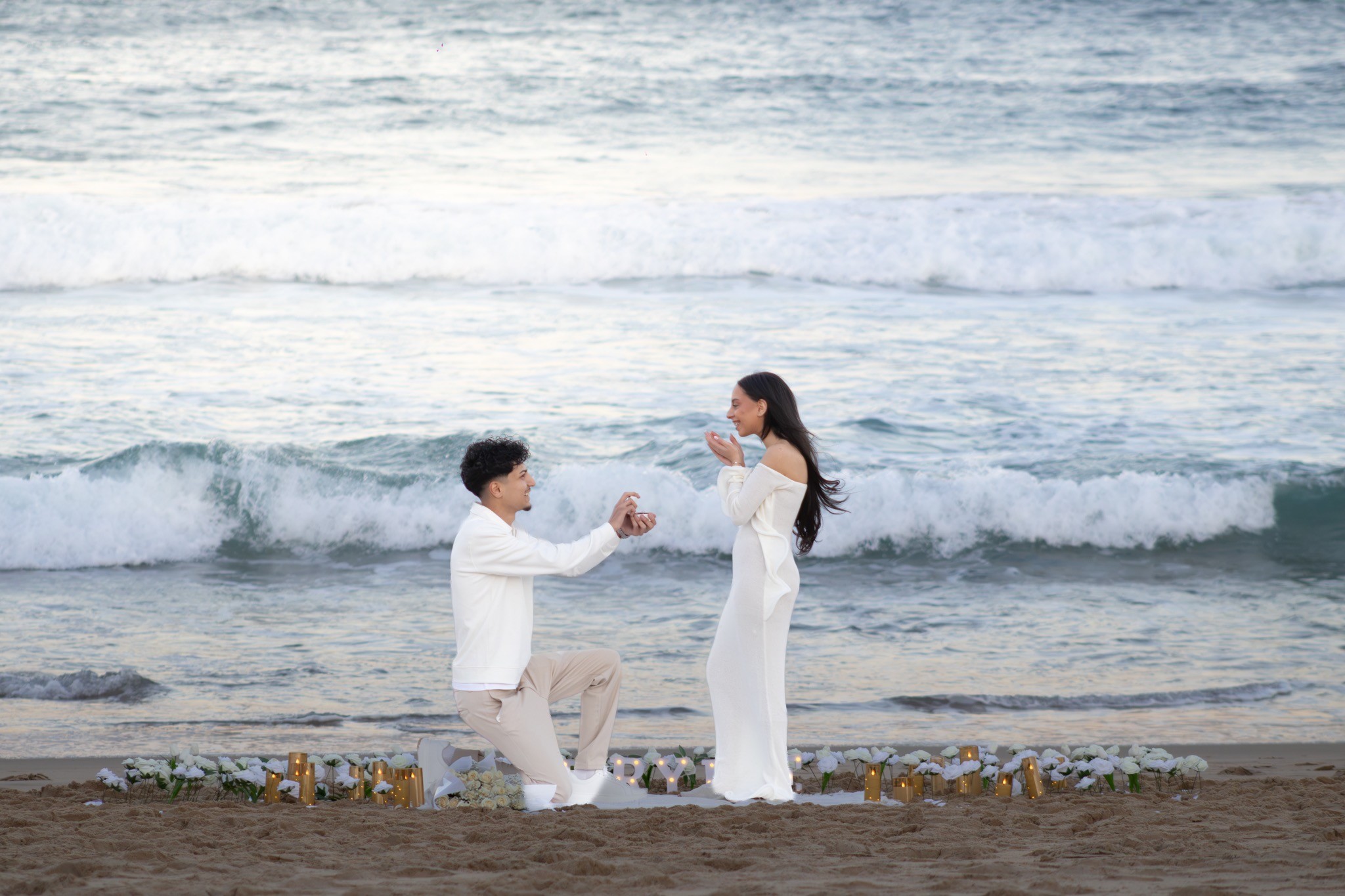 Beach proposal moment beside the ocean